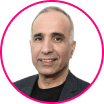 Portrait of a middle-aged man with short gray hair, wearing a dark blazer and black shirt, pictured against a white background with a pink circular border—ideal for discussing account takeover fraud and cybersecurity.